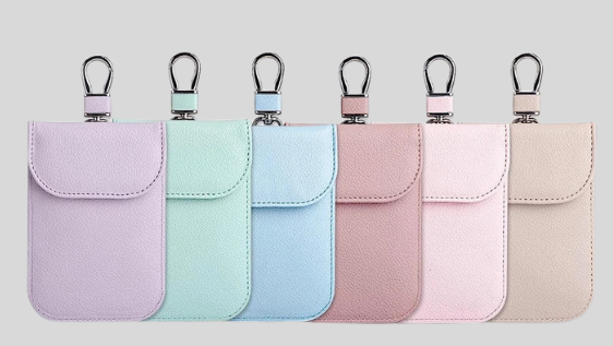 Set of small faraday pouches in various colors on a light gray background